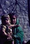 Young girl caring for younger sibling in Boir Ahmad by Reinhold Loeffler