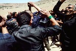 Men beating their chests at Ashura celebration by Reinhold Loeffler