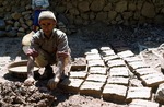 Mud bricks being made for traditional home by Reinhold Loeffler