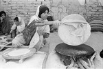 Woman baking bread in Boir Ahmad by Reinhold Loeffler