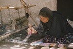 Woman at traditional horizontal loom, Boir Ahmad by Reinhold Loeffler