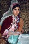 Girl baking bread in a black tent of transhumance pastoralists, Boir Ahmad by Reinhold Loeffler