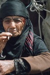 Woman smoking a cigarette in Boir Ahmad by Reinhold Loeffler