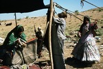 Transhumance pastoralists setting up new camp site, Boir Ahmad by Reinhold Loeffler