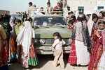 Truck transferring bride to husband's home, piled full of wedding participants, rural Boir Ahmad by Reinhold Loeffler
