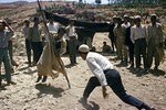 Men's stick dance at wedding, rural Boir Ahmad by Reinhold Loeffler
