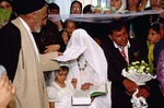 Mullah reads from Q'oran at modern wedding by Reinhold Loeffler